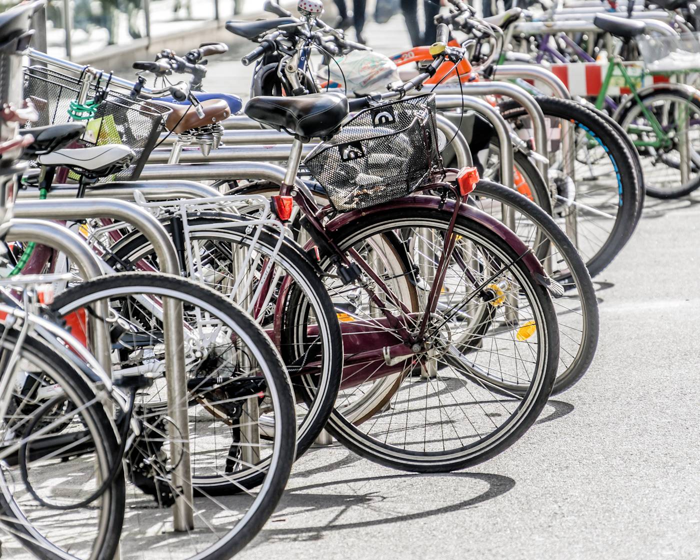 A long row of bikes parked in sheffield stands