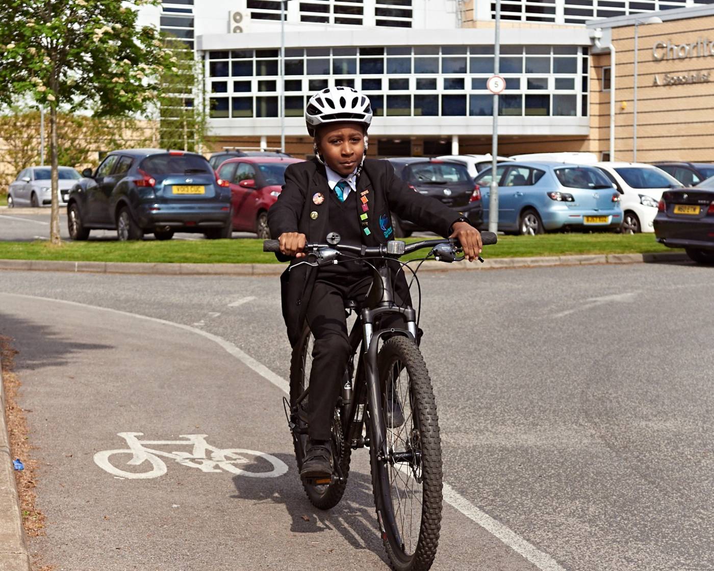 Image of school child cycling on a cycle lane