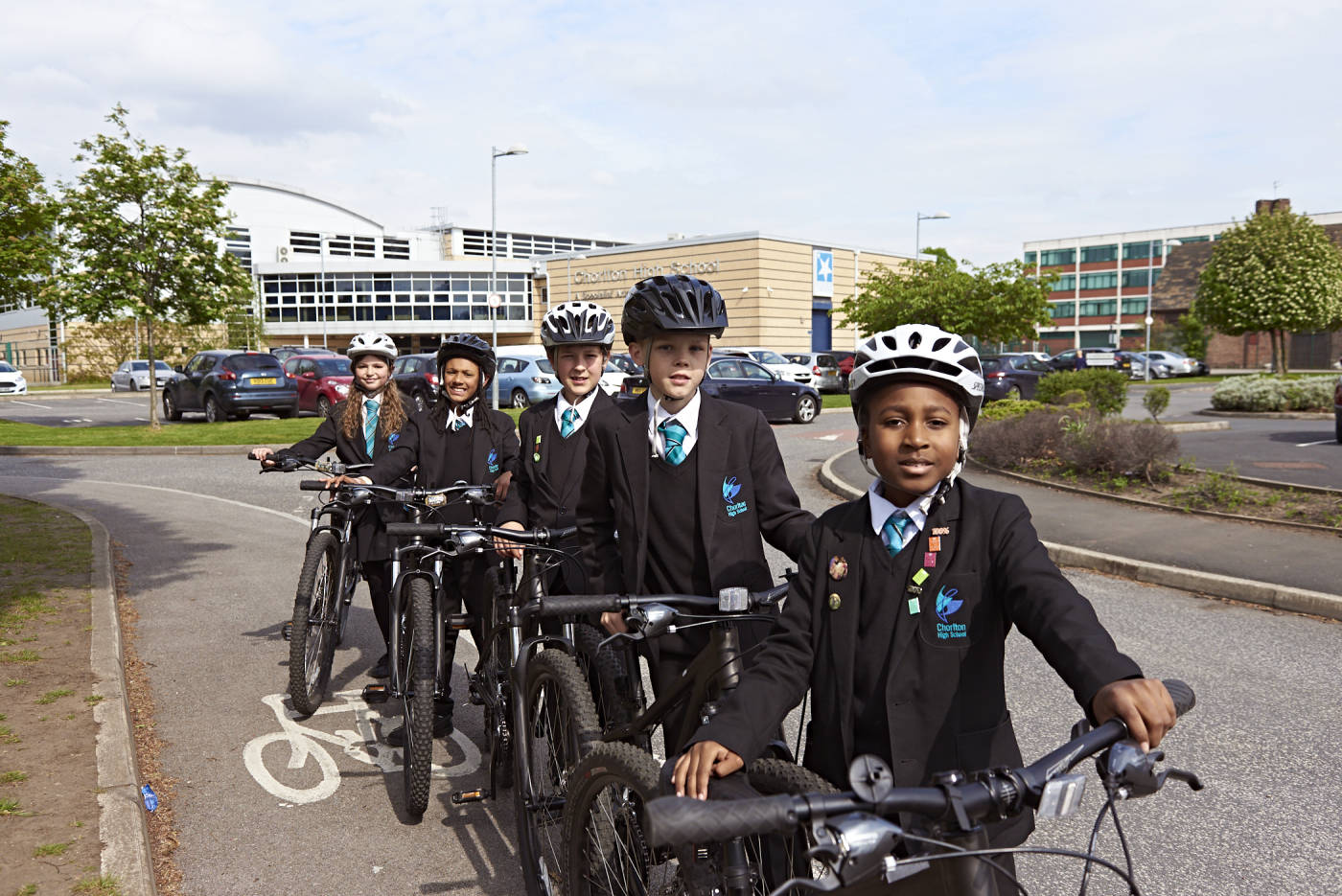 High school students stood next to their bikes on a cycle lane