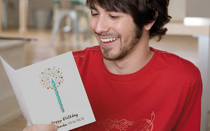 Man opening Happy Birthday Card Single Candle Image