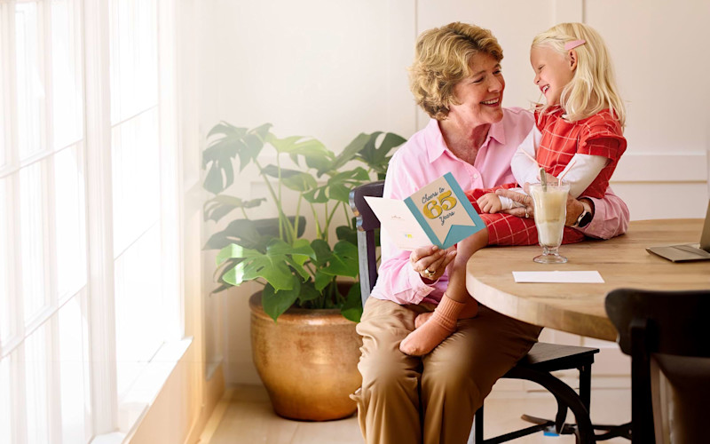 Older Woman with Blonde Girl Reading Card ARTICLE HERO