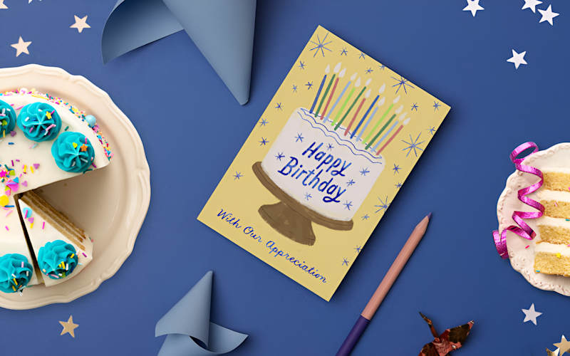 What to write in a client birthday card navy table setting with cake and happy birthday card ARTICLE HERO IMAGE