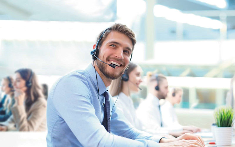 Call center representative smiling ARTICLE HERO IMAGE