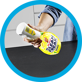 A person cleaning a kitchen countertop with CleanFreak - Lemon Scented