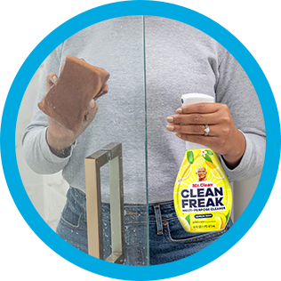 A person cleaning soup scum of shower glass with CleanFreak - Lemon Scented