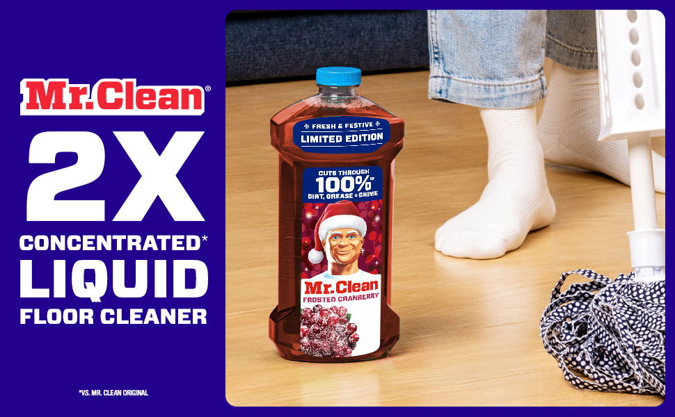 Mr Clean Frosted Cranberry floor cleaner bottle on wooden floor with person in white socks and cleaning supplies nearby