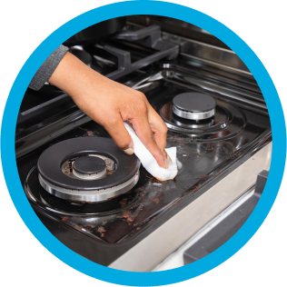 Mr. Clean wipe cleaning dirt from a stovetop