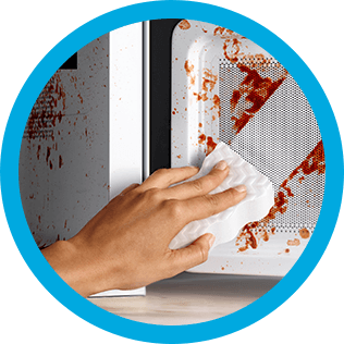 Mr. Clean wipe erasing stains from a microwave