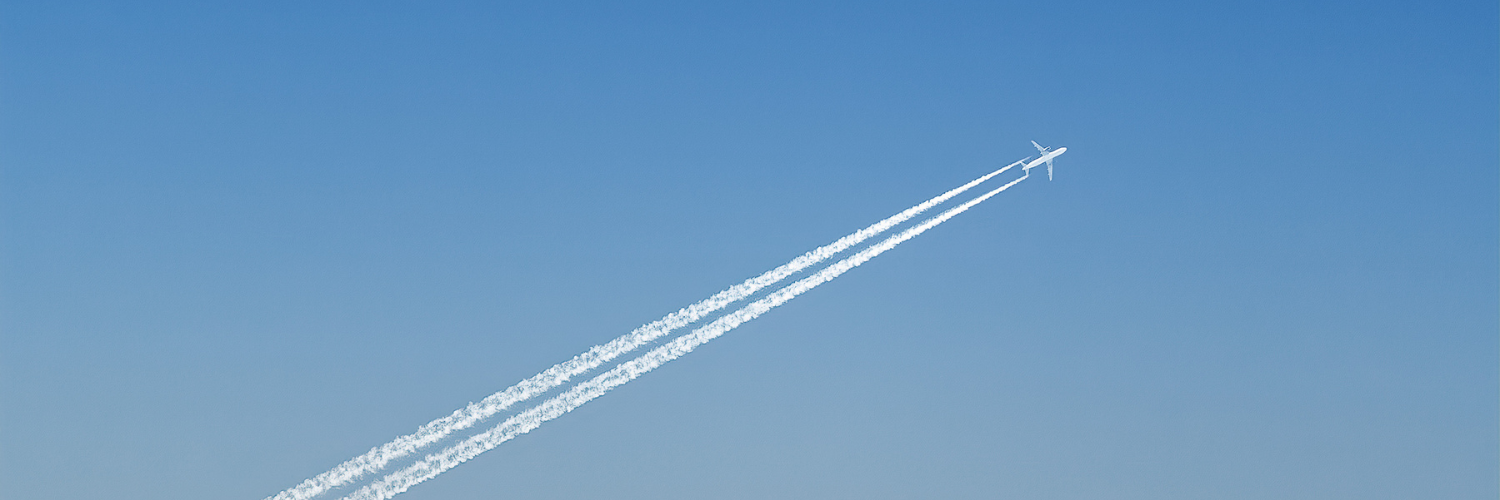 Distant airplane with jet trail