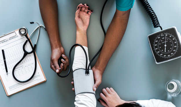 Nurse taking a patient's heart rate.