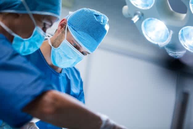Close-up of two surgeons operating.