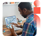 Content marketer sitting at computer, holding mobile device