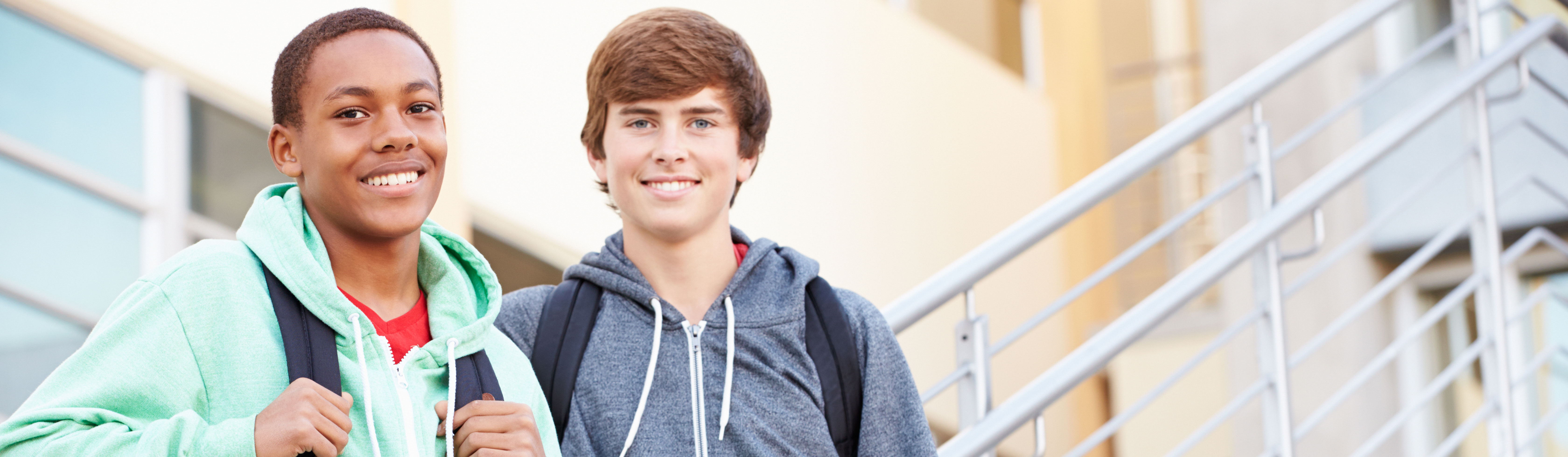 Students smiling on school stairs