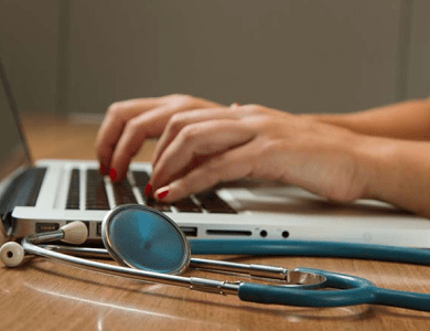 Missouri Foundation for Health woman typing on laptop with stethoscope 