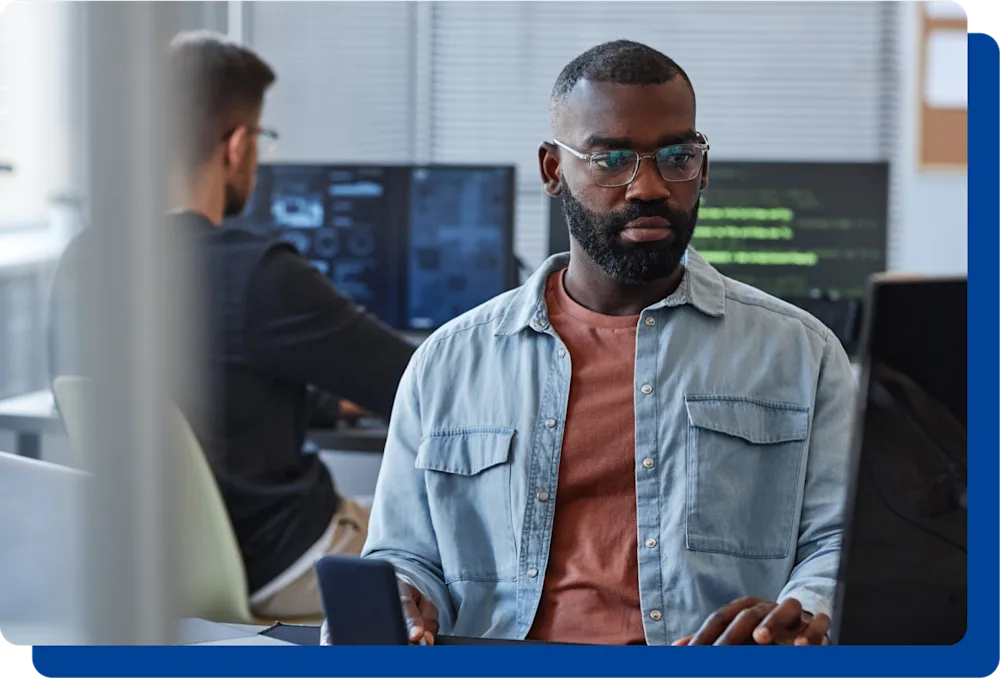 man with glasses on the computer