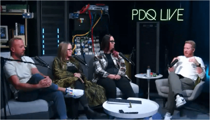 PDQ webinar panel discusses shadow AI risks in IT environments, with four speakers seated in a studio surrounded by networking equipment and microphones.