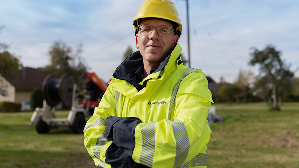 Netze-BW-Mitarbeiter mit Helm und Arbeitskleidung.