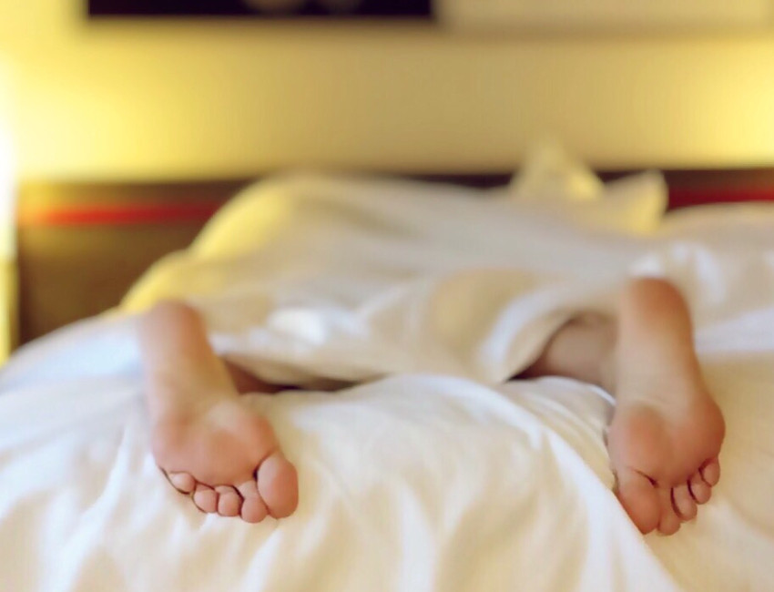 person sleeping face down on bed