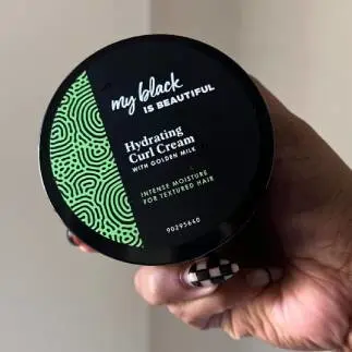 Hand holding Hydrating Curl Cream