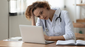 Stressed doctor at computer