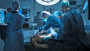 Medical team performing defibrillation on patient in hospital