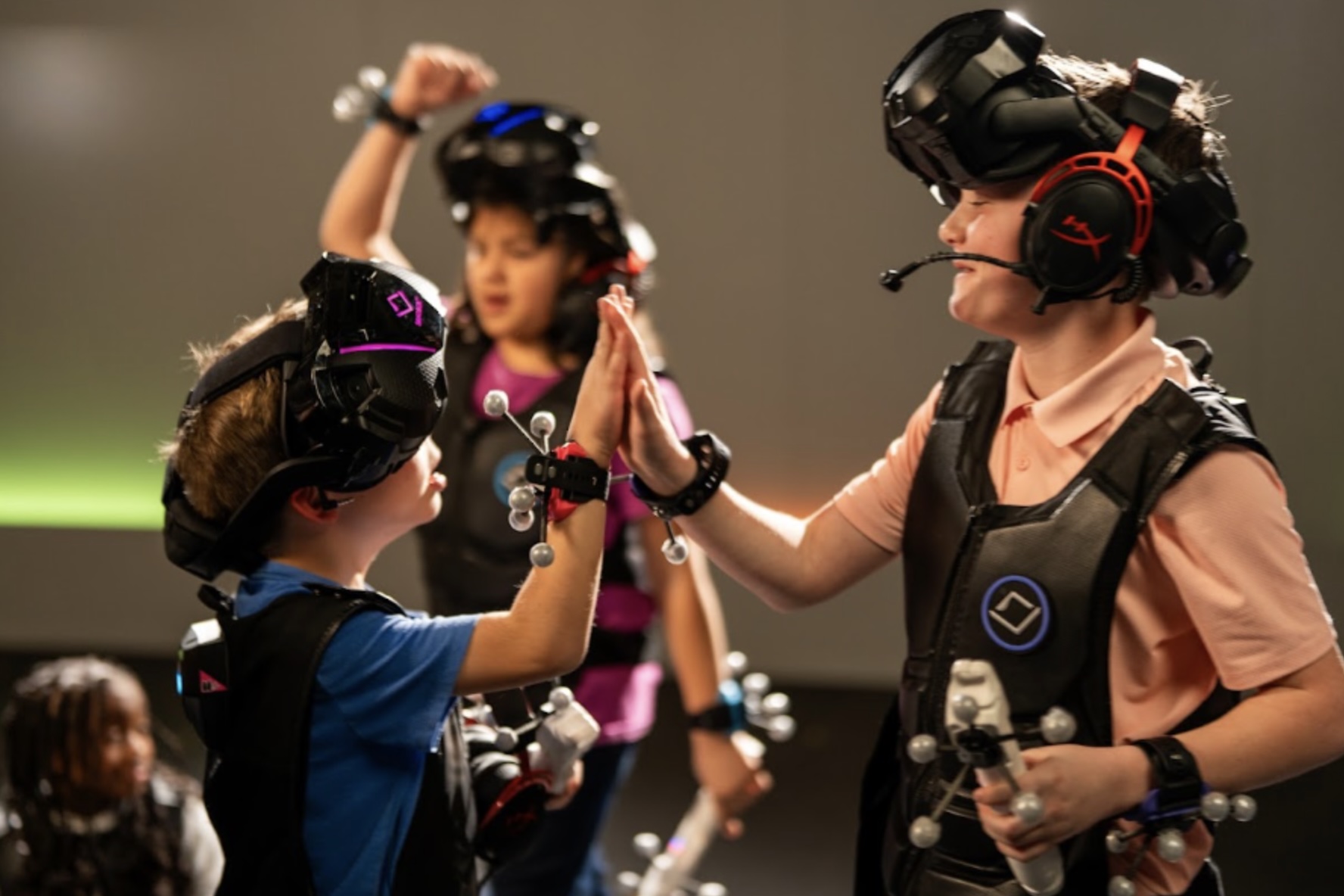 Kids high-fiving in Age of Dinosaurs experience