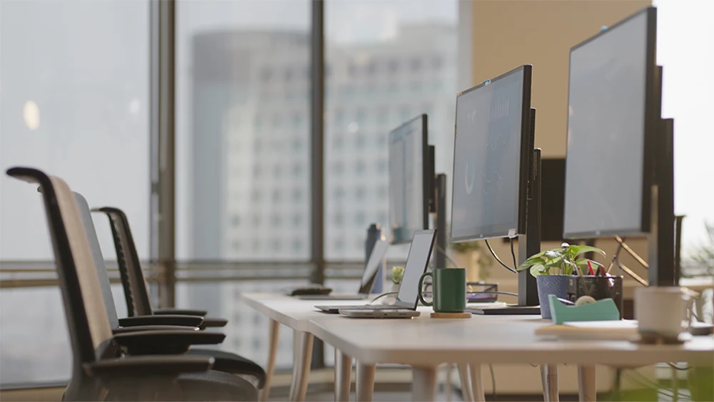 Computer monitors on desks in an office setting
