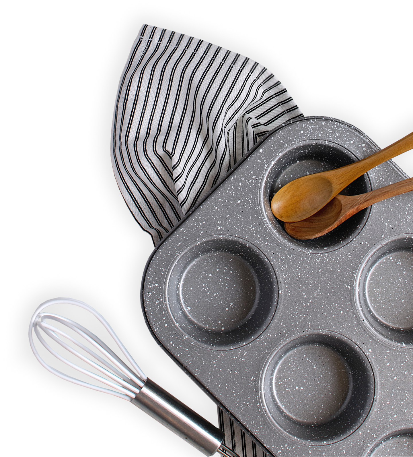 Baking pan, whisk, and two wooden spoons laying on top of a dish towel.