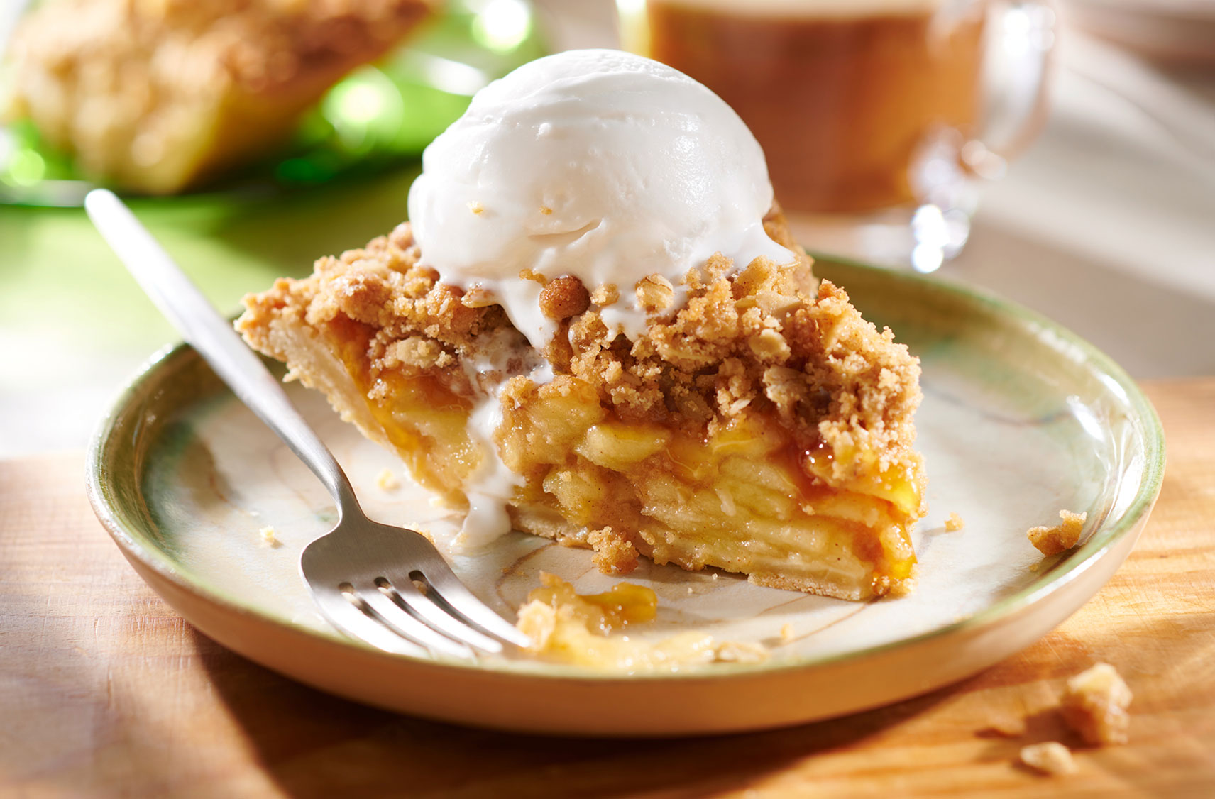 A slice of plant-based apple pie a la mode on a plate ready to be served