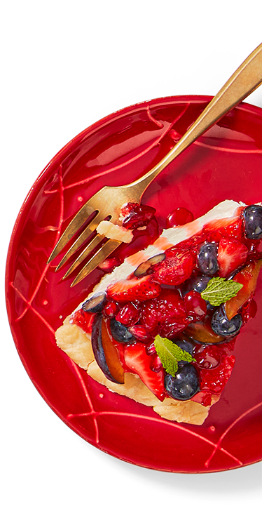 A slice of fruit topped dessert