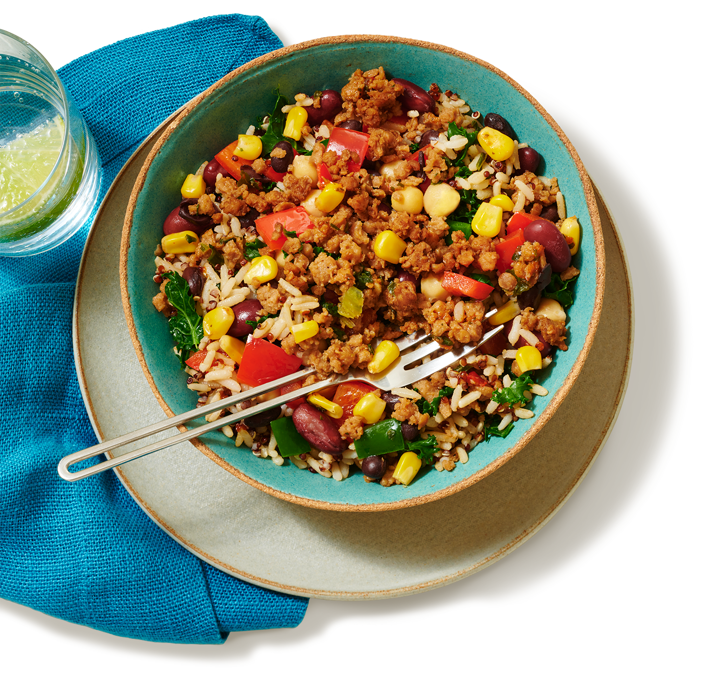 A bowl of chili which is comprised of a mixture of corn, tomatoes seasoning and veggie ground