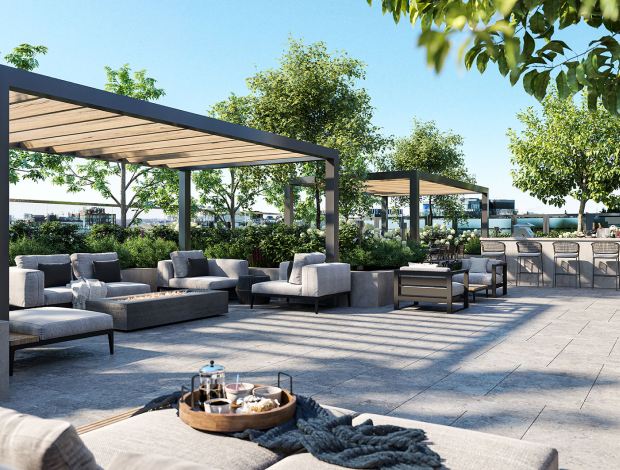 A collection of outdoor patio loungers and tables under a Canopy at The Well Condo