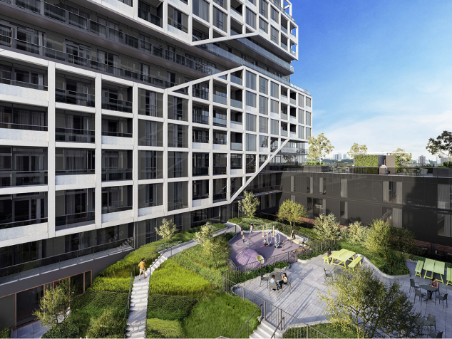 A lush green courtyard surrounded by a condo building