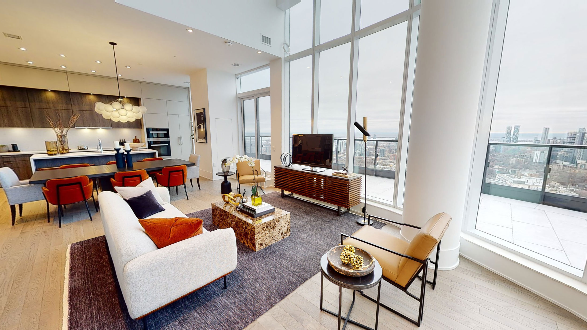 Wide angle view of Via Bloor's Penthouse 22 Living Room and Kitchen