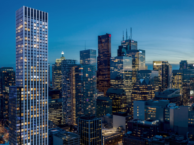 A Condo Building with many lights on with the a night time city skyline in the background