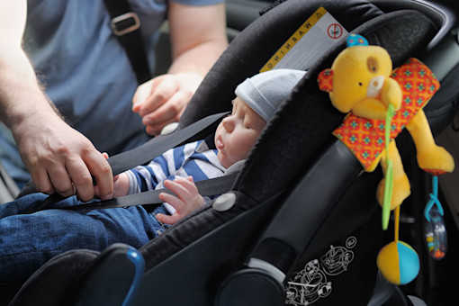 Baby asleep in the back of a car