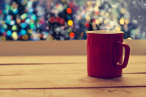 Cup of tea with Christmas lights in the background