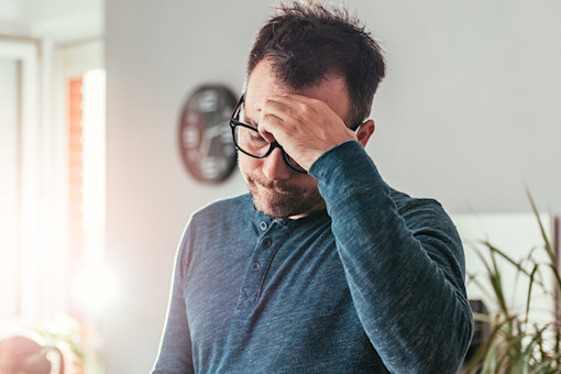 Worried father looking at smartphone