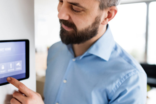 Man looking at smart home device