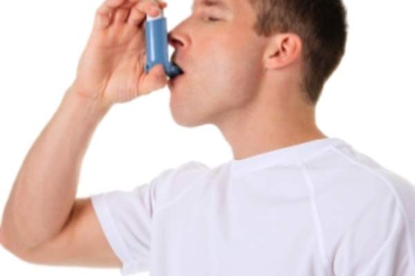 Man using inhaler for asthma.