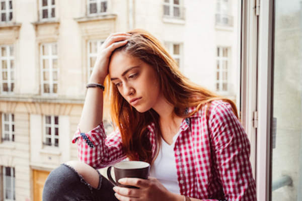 Depressed woman lack of sleep, looking out window