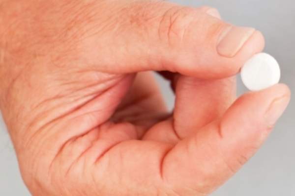 Man holding a pill.
