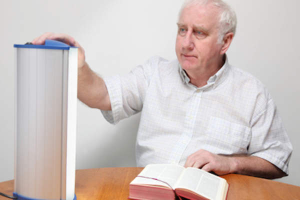 Man adjusting his light box