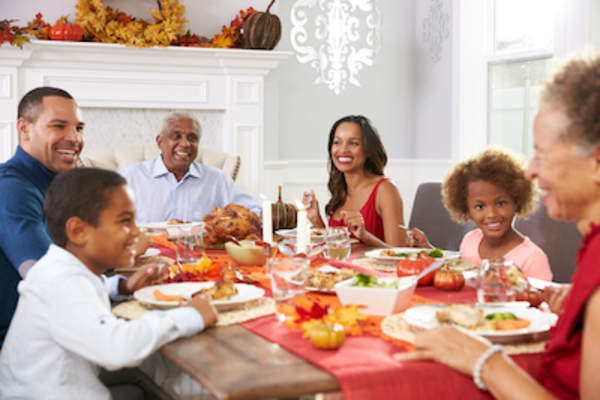 Happy family enjoying each other's company at holiday meal.