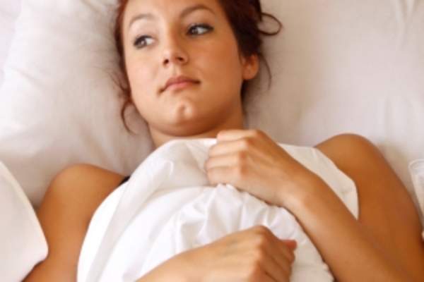 Woman lying in bed.