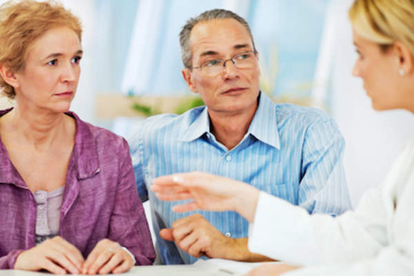 Couple talking with doctor