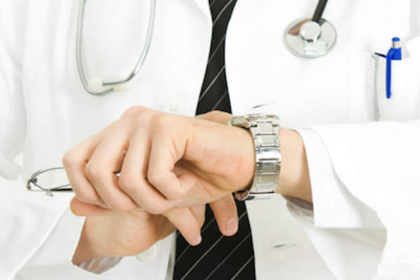 Doctor checking watch.
