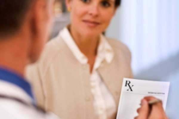 Doctor and patient with prescription.