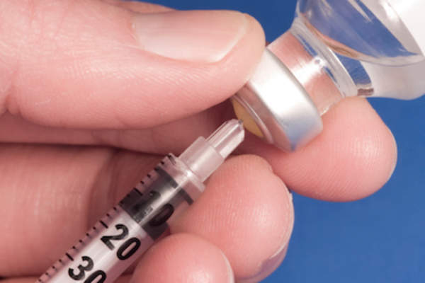 Syringe in vaccine vial