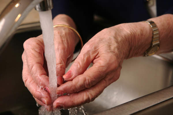 Senior woman washing hands